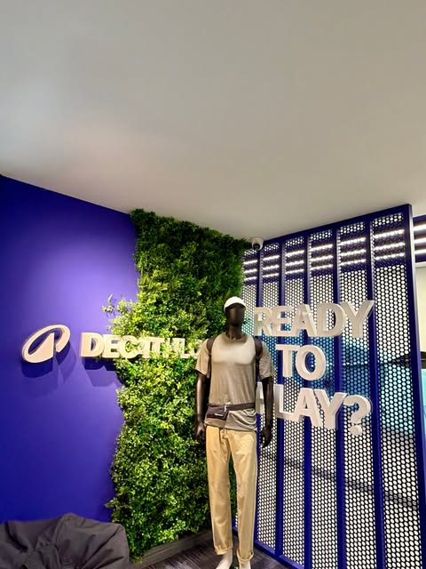 Decathlon wall with dimensional letters and a large READY TO PLAY? graphic beside a planted wall.
